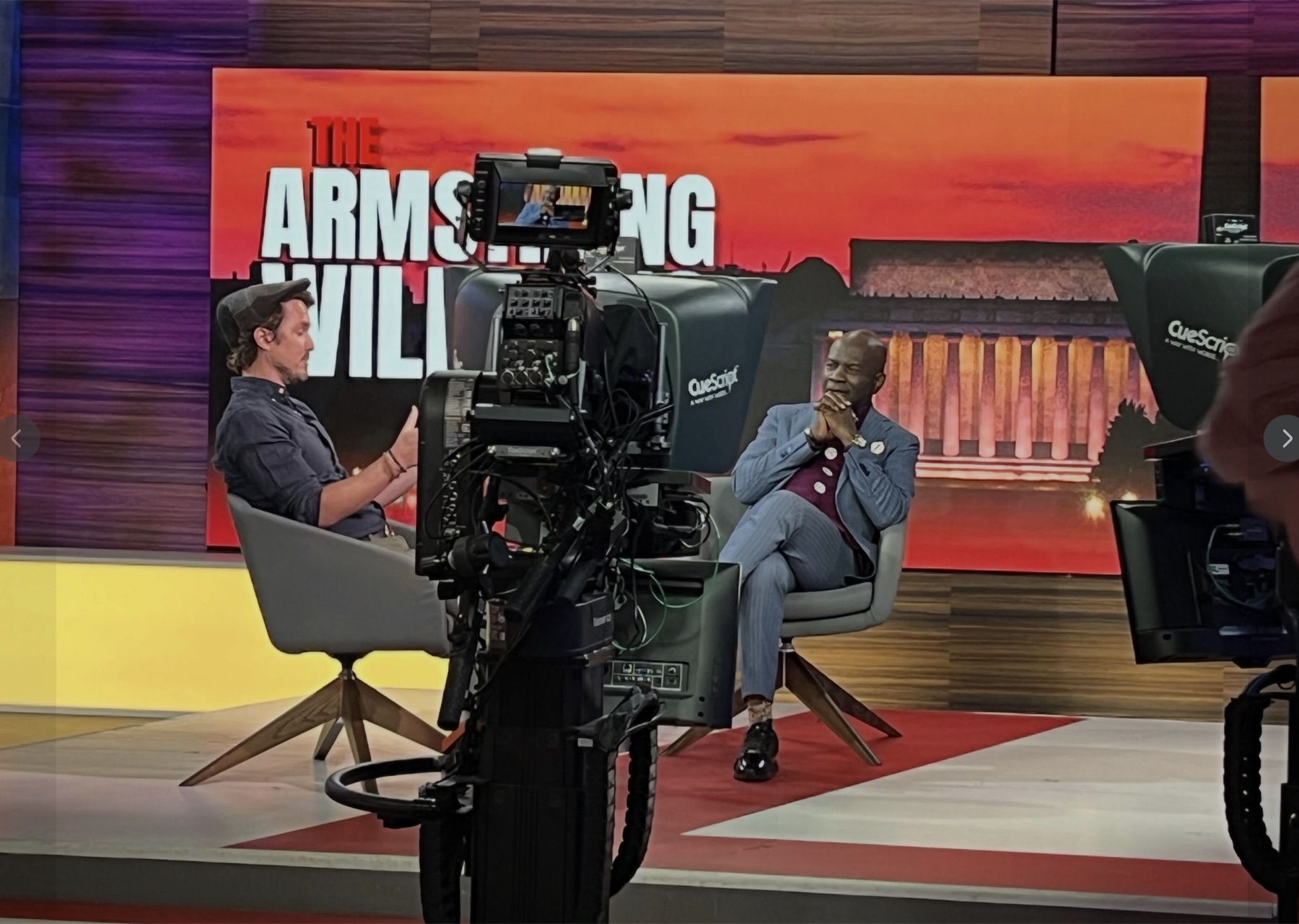 Dugan Bridges speaking with Armstrong Williams on set